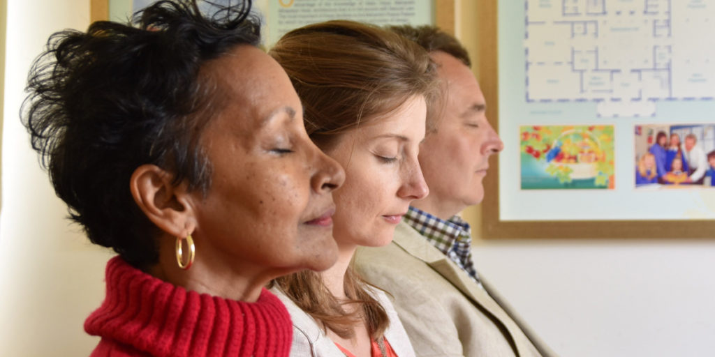 Three people meditating